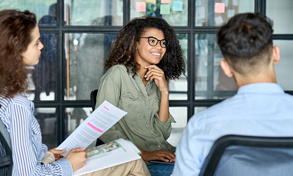 girl in glasses smiling in a meeting