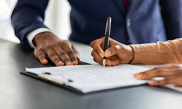 hands signing contract